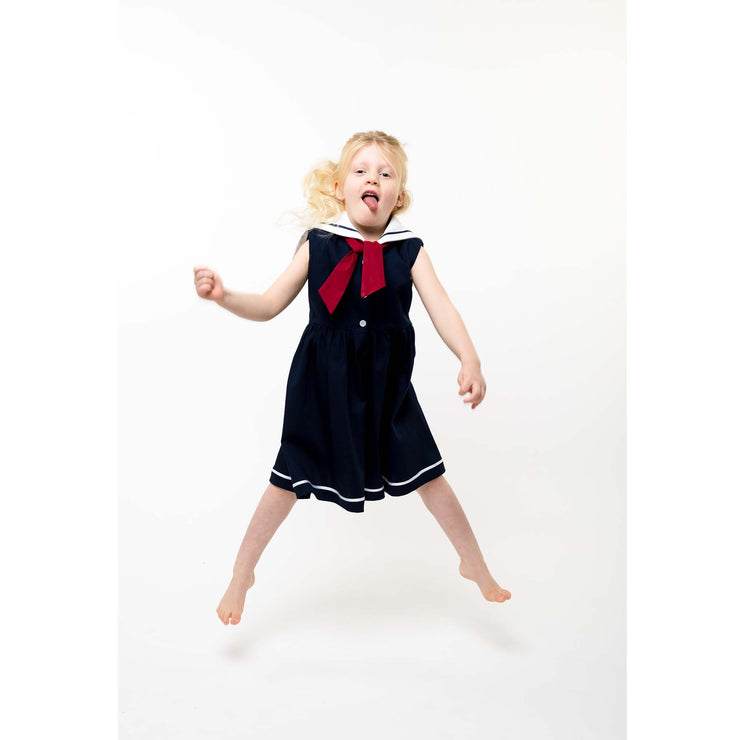 girl in sailor dress jumping