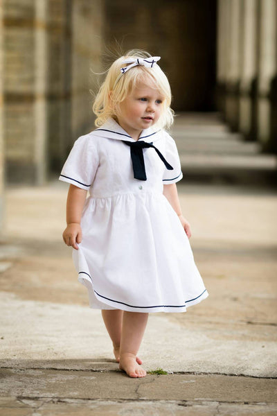 girl in a white linen sailor dress